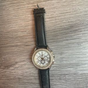Women’s watch black strap white face gold numbering. Used condition like new.